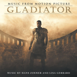 Promotional Gladiator poster showing a warrior in ancient armor in a dusty arena, with 'Music From Motion Picture' at the top and composer credits at the bottom.