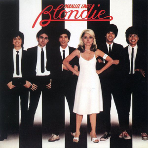 Debbie Harry in a white dress with hands on hips, flanked by men in suits, on Blondie's Parallel Lines album cover.