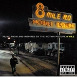 Nighttime album cover featuring a glowing neon sign reading '8 Mile Rd' over a mobile home street, with a lone man walking along the road and a parental advisory label in the corner.
