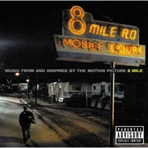 Nighttime album cover featuring a glowing neon sign reading '8 Mile Rd' over a mobile home street, with a lone man walking along the road and a parental advisory label in the corner.