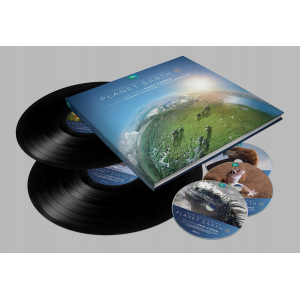 Vinyl record set with a blue Planet Earth II soundtrack sleeve and several discs showing animal imagery, arranged on a gray background.