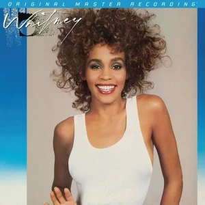 Smiling woman with curly hair in a white sleeveless top, against a blue promotional background reading 'Original Master Recording'. (Album cover)