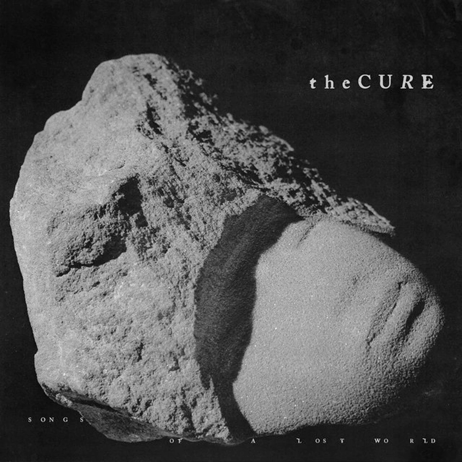 0602468033776 - ELPÉČKO.sk Album cover with a rough rock formation against a black background and 'the Cure' text in the upper right.