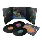 Three black vinyl records with vibrant abstract artwork on their sleeves and a tri-fold gatefold cover set.