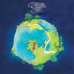 Album cover featuring a stylized globe with landmasses in green and blue, a wooden ship near the bottom, and the title 'Fragile Eyes' in white script above on a dark blue background